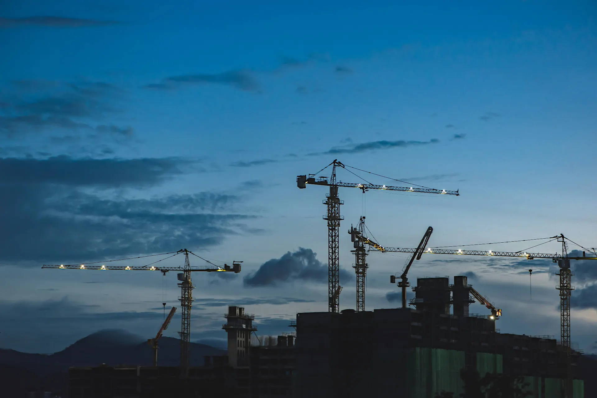 Construction cranes and industrial infrastructure at a development site